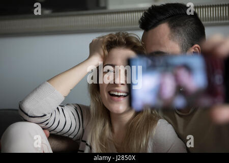 Happy couple taking selfie at home Stock Photo