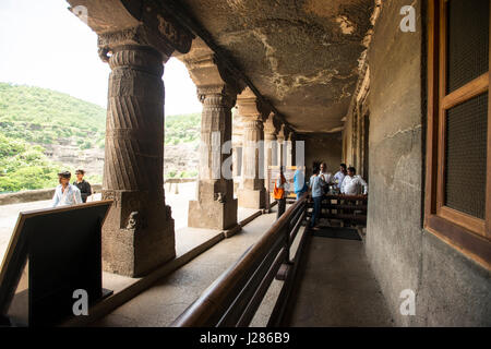 Tourists enter a cave at Ajanta, Aurangabad, India Stock Photo