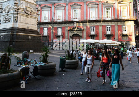 Locals and tourist hang around the popular Piazza San Domenico Maggiore in the old city of  Naples. Stock Photo