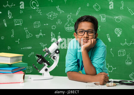 cute indian kids doing science experiment in chemistry lab or biology lab in school Stock Photo