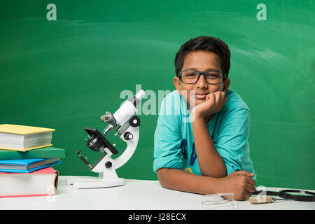 cute indian kids doing science experiment in chemistry lab or biology lab in school Stock Photo