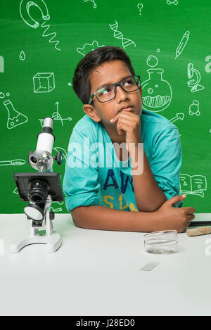 cute indian kids doing science experiment in chemistry lab or biology lab in school Stock Photo