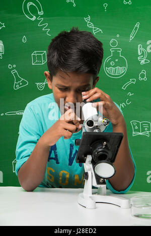 cute indian kids doing science experiment in chemistry lab or biology lab in school Stock Photo