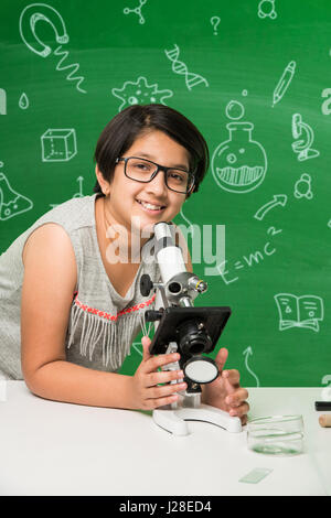 cute indian kids doing science experiment in chemistry lab or biology lab in school Stock Photo