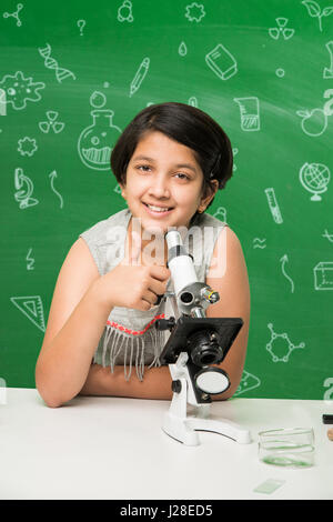 cute indian kids doing science experiment in chemistry lab or biology lab in school Stock Photo