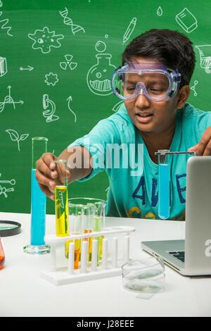 cute indian kids doing science experiment in chemistry lab or biology lab in school Stock Photo