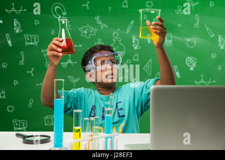 cute indian kids doing science experiment in chemistry lab or biology lab in school Stock Photo