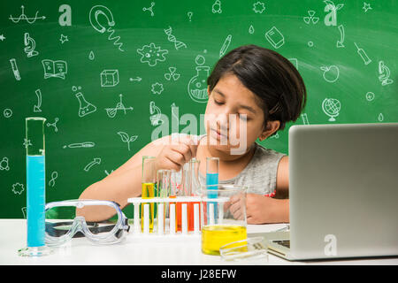 cute indian kids doing science experiment in chemistry lab or biology lab in school Stock Photo