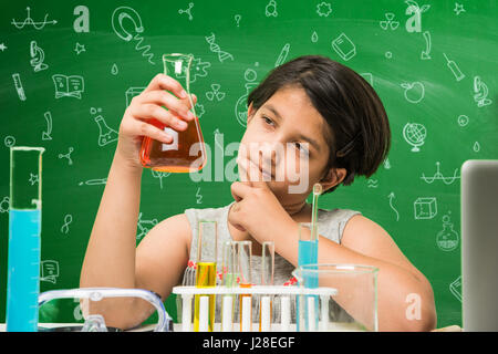 cute indian kids doing science experiment in chemistry lab or biology lab in school Stock Photo