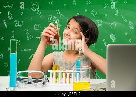cute indian kids doing science experiment in chemistry lab or biology lab in school Stock Photo