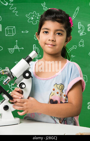 cute indian kids doing science experiment in chemistry lab or biology lab in school Stock Photo
