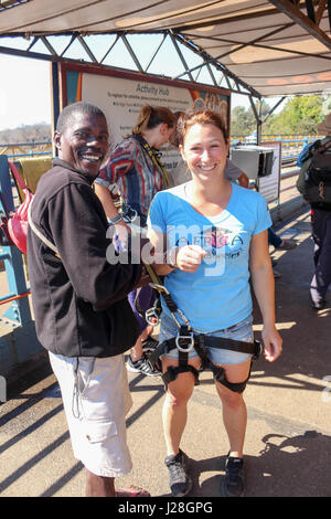 Zambia, Victoria Falls, Sambesi river, woman gets secured belts for the bungee jump Stock Photo