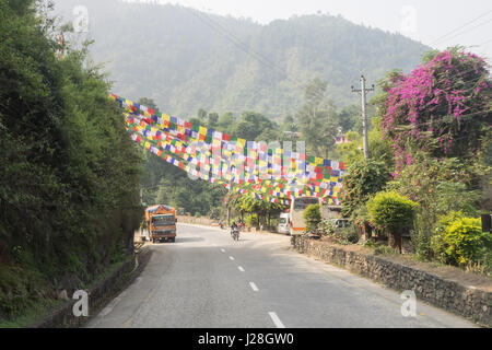 Nepal, Central Region, Benighat, Annapurna Circuit - Drive Kathmandu to Bhulbhule - Prayer flags decorate the country road west of Kathmandu Stock Photo