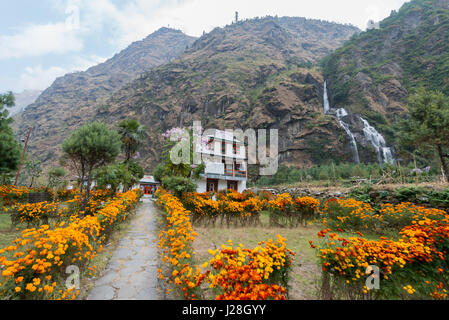 Nepal, Western Region, Dharapani, On the Annapurna Circuit - Day 2 - From Jagat to Dharapani - Garden with waterfall in the valley Stock Photo