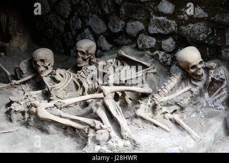 Replica skeletons in the position that the bodies were found after volcanic flow  in 79AD Herculaneum Ercolana Campania Italy Stock Photo