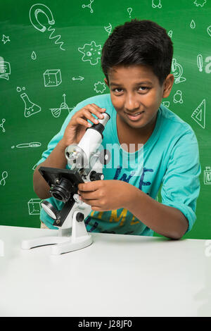 cute indian kids doing science experiment in chemistry lab or biology lab in school Stock Photo