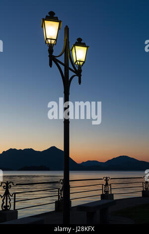 Ornate railings and lamppost on lakeside promenade with stunning views at dawn at Baveno, Lake Maggiore, Italy in April Stock Photo