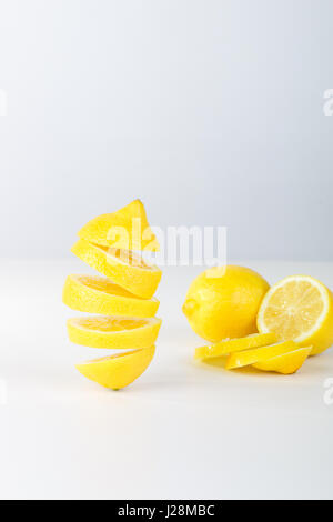 Flying lemon. Sliced lemon on white background. Levity fruit floating in the air Stock Photo