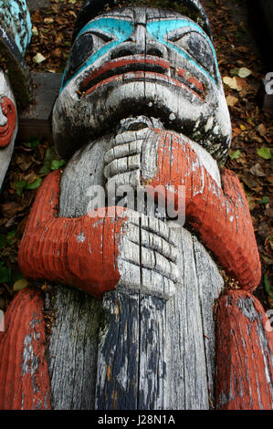Human  carving on Totem pole laying on the ground, Tlingit Indians, Haines, Alaska