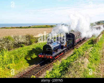 A steam train on the North Norfolk Railway crests Dead Man's Hill between Sheringham & Weybourne. Stock Photo