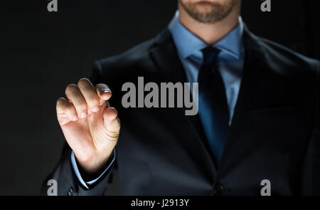 close up of businessman touching virtual screen Stock Photo