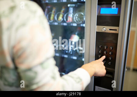 hand pushing button on vending machine keyboard Stock Photo