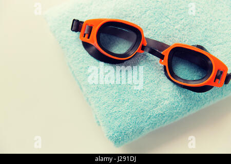 close up of swimming goggles and towel Stock Photo