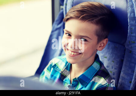 happy boy sitting in travel bus or train Stock Photo