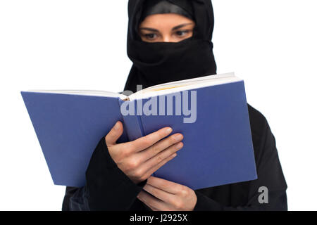 muslim woman in hijab reading book over white Stock Photo