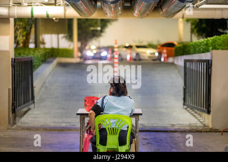 Security guard in car park.- (Selective focus) Stock Photo