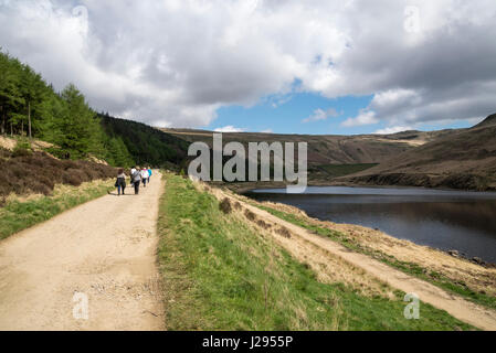 Group of walkers beside Yeoman hey reservoir, Dove Stones, Greater Manchester, England Stock Photo