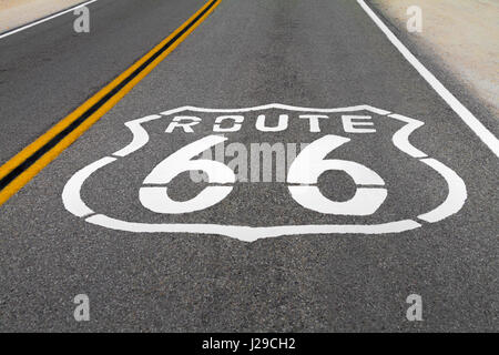 The Route 66 logo on the floor of the road with double yellow lines. Stock Photo
