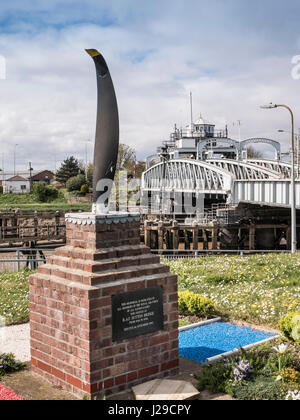 RAF memorial in front of the Crosskeys swing bridge at Sutton Bridge in Lincolnshire which was built in 1897. Stock Photo