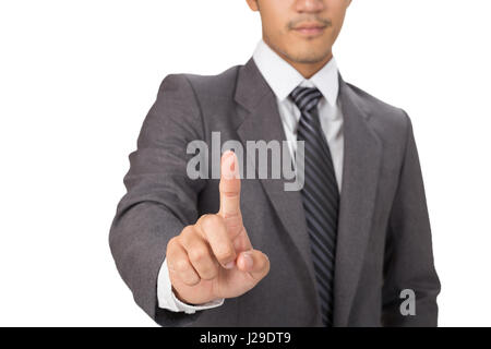 young businessman pressing an imaginary button on a touch screen interface Stock Photo