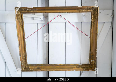 Old wooden painting frame hanging on the wooden doors Stock Photo