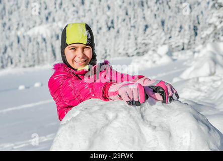 Little girl playing in snow in Montenegro Stock Photo