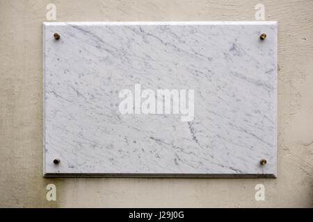 Empty marble plate on a painted wall Stock Photo