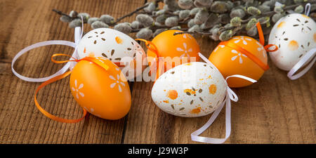 Orange and white Easter eggs decorations with spring buds branches Stock Photo
