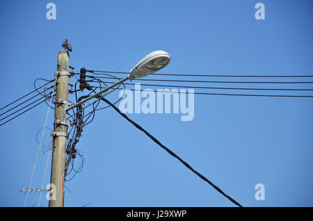 Lamp post with many cables that run in different directions Stock Photo