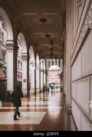 BOLOGNA, ITALY - FEBRUARY 06, 2017. People walking through a covered walkway. Stock Photo