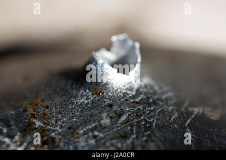 Macro shot of bullet holes after a target shooting in a aluminum pan. Stock Photo