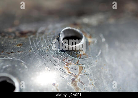 Macro shot of bullet holes after a target shooting in a aluminum pan. Stock Photo