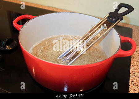 Candy Thermometer in Pot of Boiling Sugar. Stock Photo