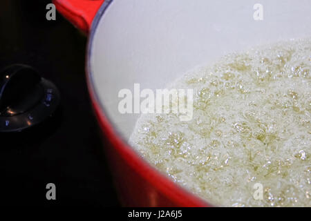 Closeup of liquid boiling in a pot. Stock Photo