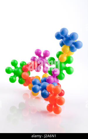 Colorful meccano plastic toys on a white surface. Meccanos isolated on white background. Stock Photo