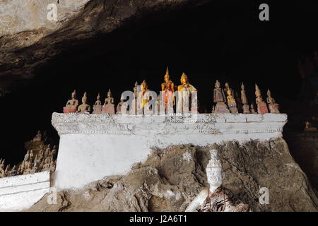 Over 4000 Buddha figures-mostly wooden crowd the Tham Ting-lower Pak Ou cave set in a vertical limestone cliff at the point where the Mekong joins the Stock Photo