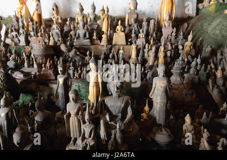 Over 4000 Buddha figures-mostly wooden crowd the Tham Ting-lower Pak Ou cave set in a vertical limestone cliff at the point where the Mekong joins the Stock Photo