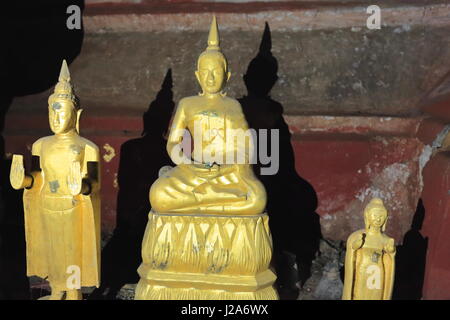 Over 4000 Buddha figures-mostly wooden crowd the Tham Ting-Tham Theung or Lower-Upper Pak Ou caves set in limestone cliff at the Mekong and Nam Ou riv Stock Photo