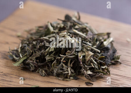 Placer of white tea on a wooden background Stock Photo