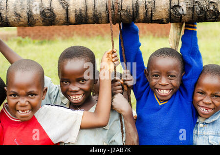 Malawi, Mzimba district, Chilumba Community Based Childcare Centre (CBCC). Portrait of smiling children on swing Stock Photo